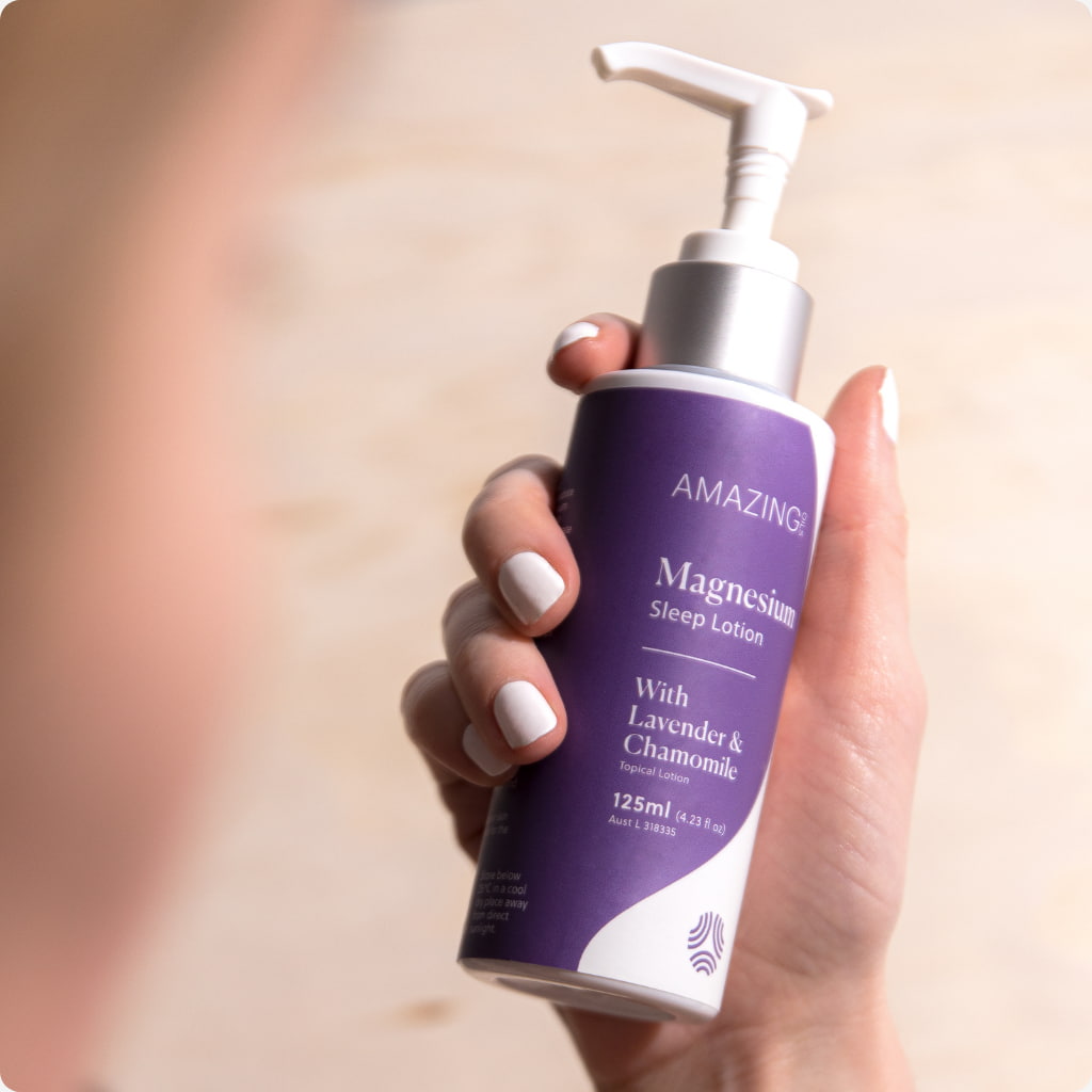 Magnesium sleep lotion dispenser hand holding bottle