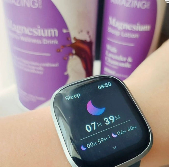 Smartwatch on a wrist displaying sleep information with purple bottles in the background