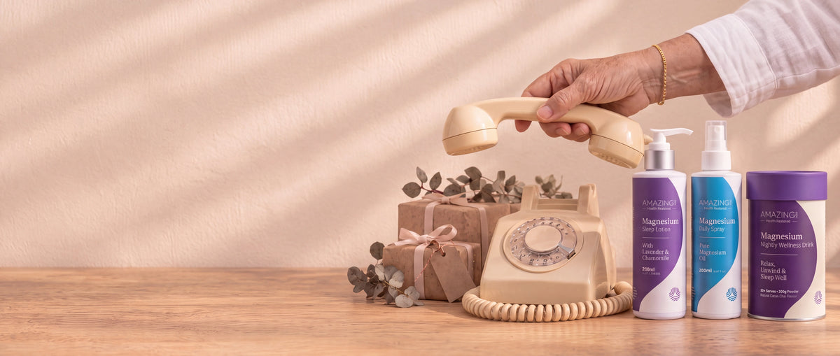 An intact cream rotary telephone beside gifts and clearly separated Amazing You magnesium products