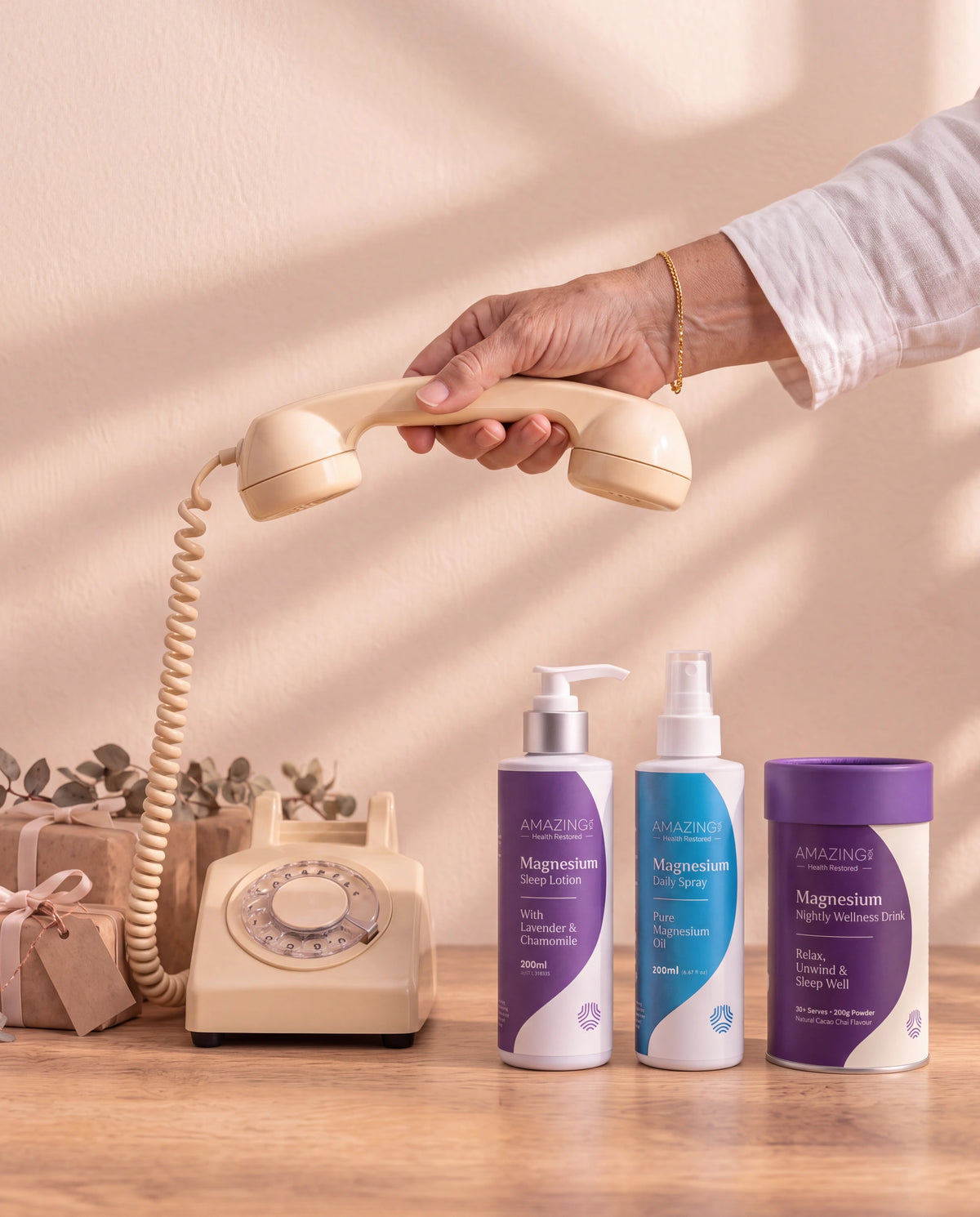 An intact cream rotary telephone beside gifts and clearly separated Amazing You magnesium products